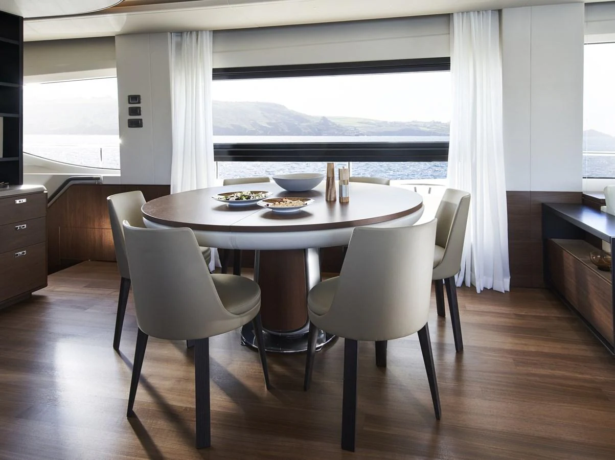 a dining table and chairs in a room with a window aboard PRINCESS 85MY 2019 Yacht for Sale