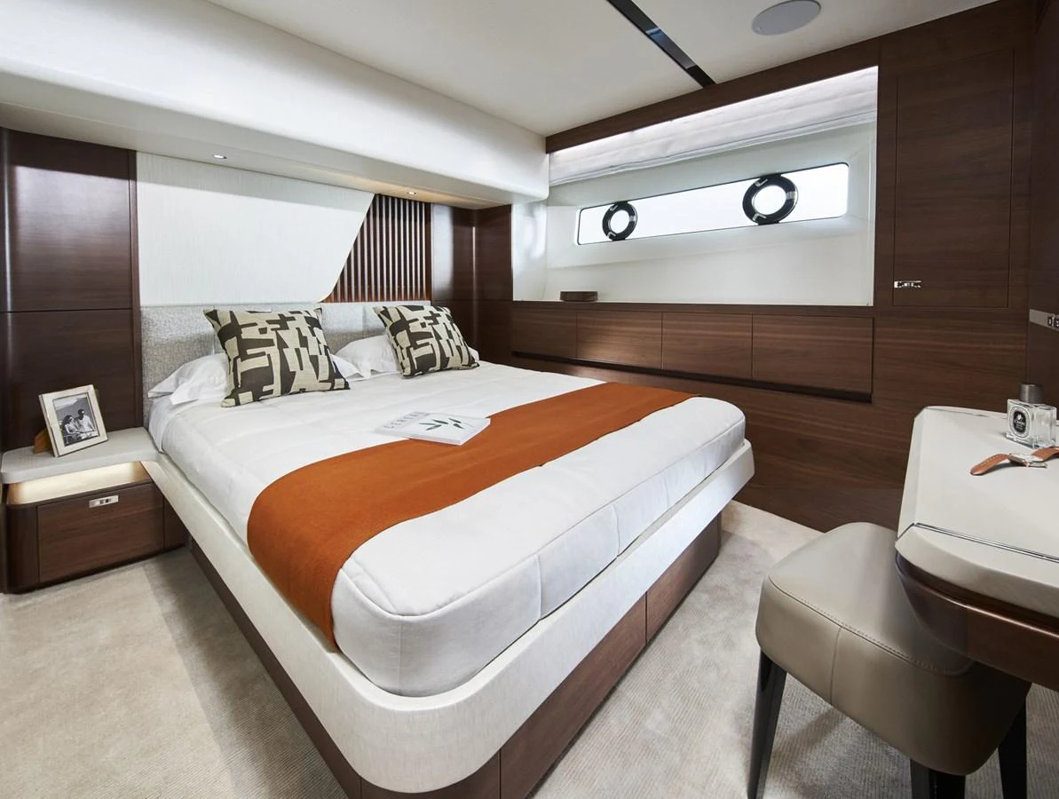 a room with a bed and a chair aboard PRINCESS 85MY 2019 Yacht for Sale