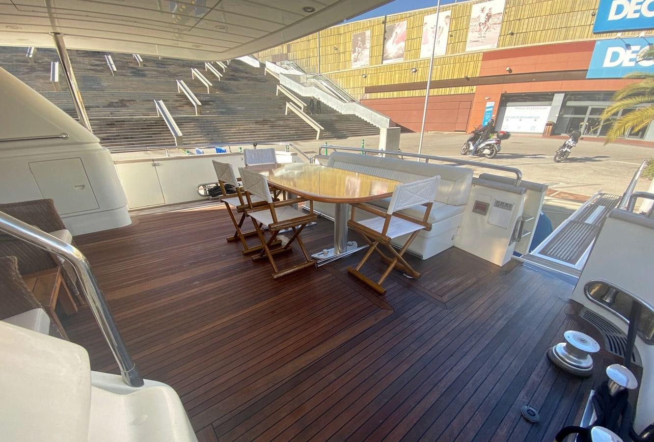a room with tables and chairs aboard GRAN FINALE II Yacht for Sale