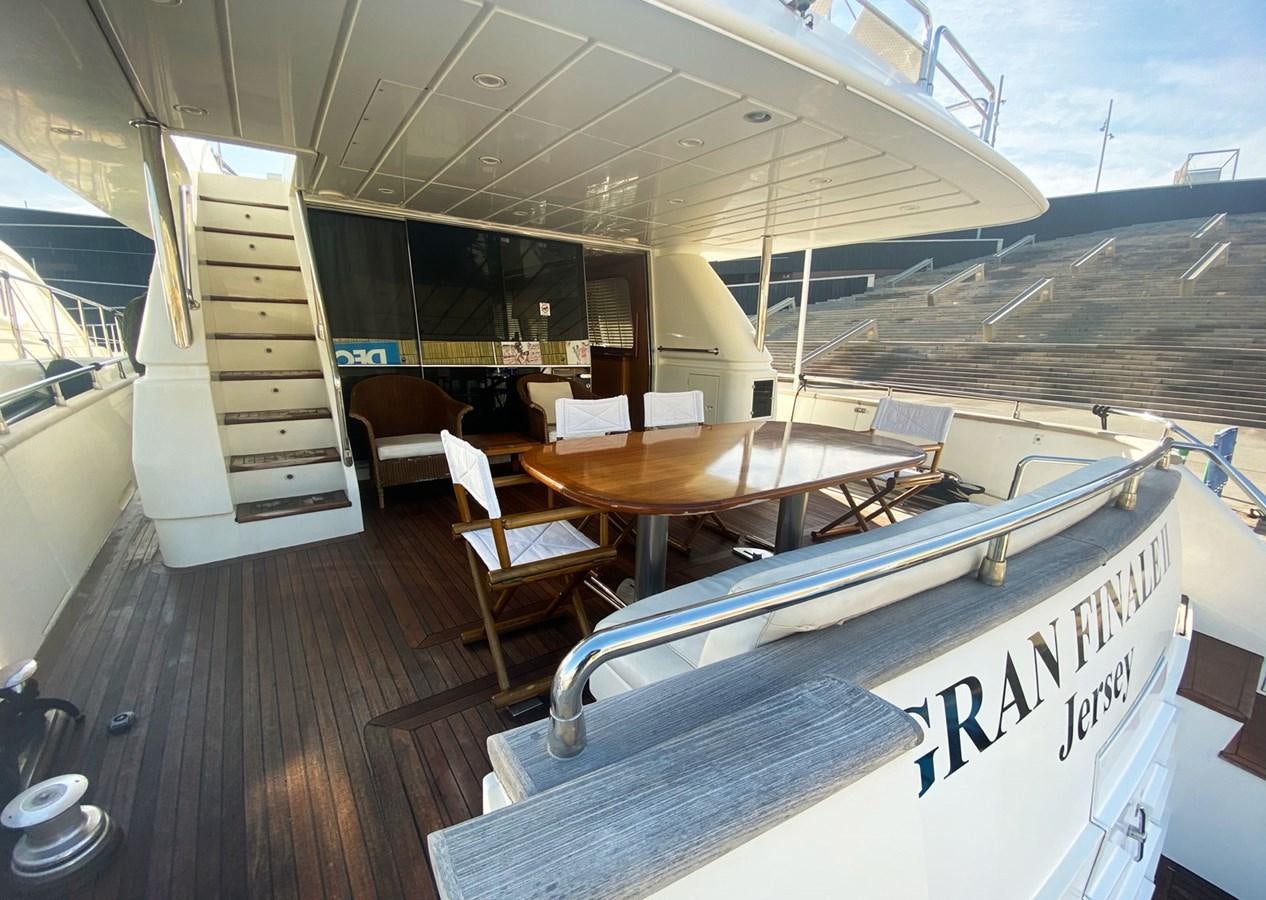 a boat with a table and chairs aboard GRAN FINALE II Yacht for Sale