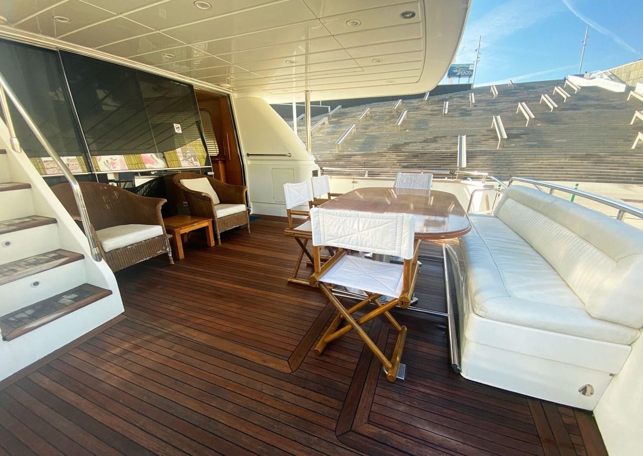 a room with a couch and a table and chairs aboard GRAN FINALE II Yacht for Sale