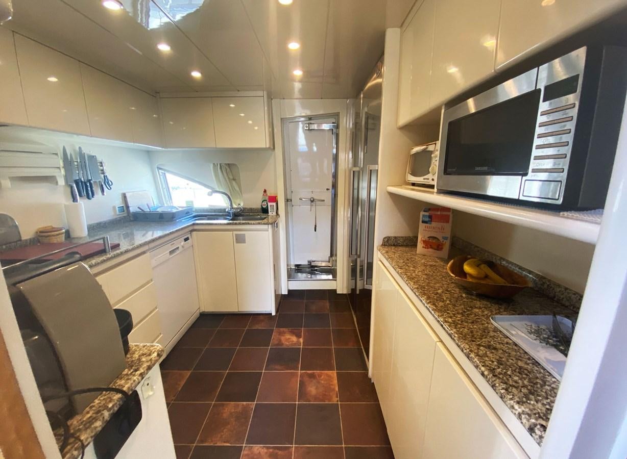 a kitchen with a tile floor aboard GRAN FINALE II Yacht for Sale