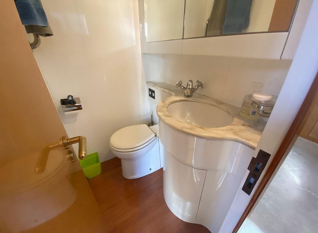 a bathroom with a sink and toilet aboard GRAN FINALE II Yacht for Sale