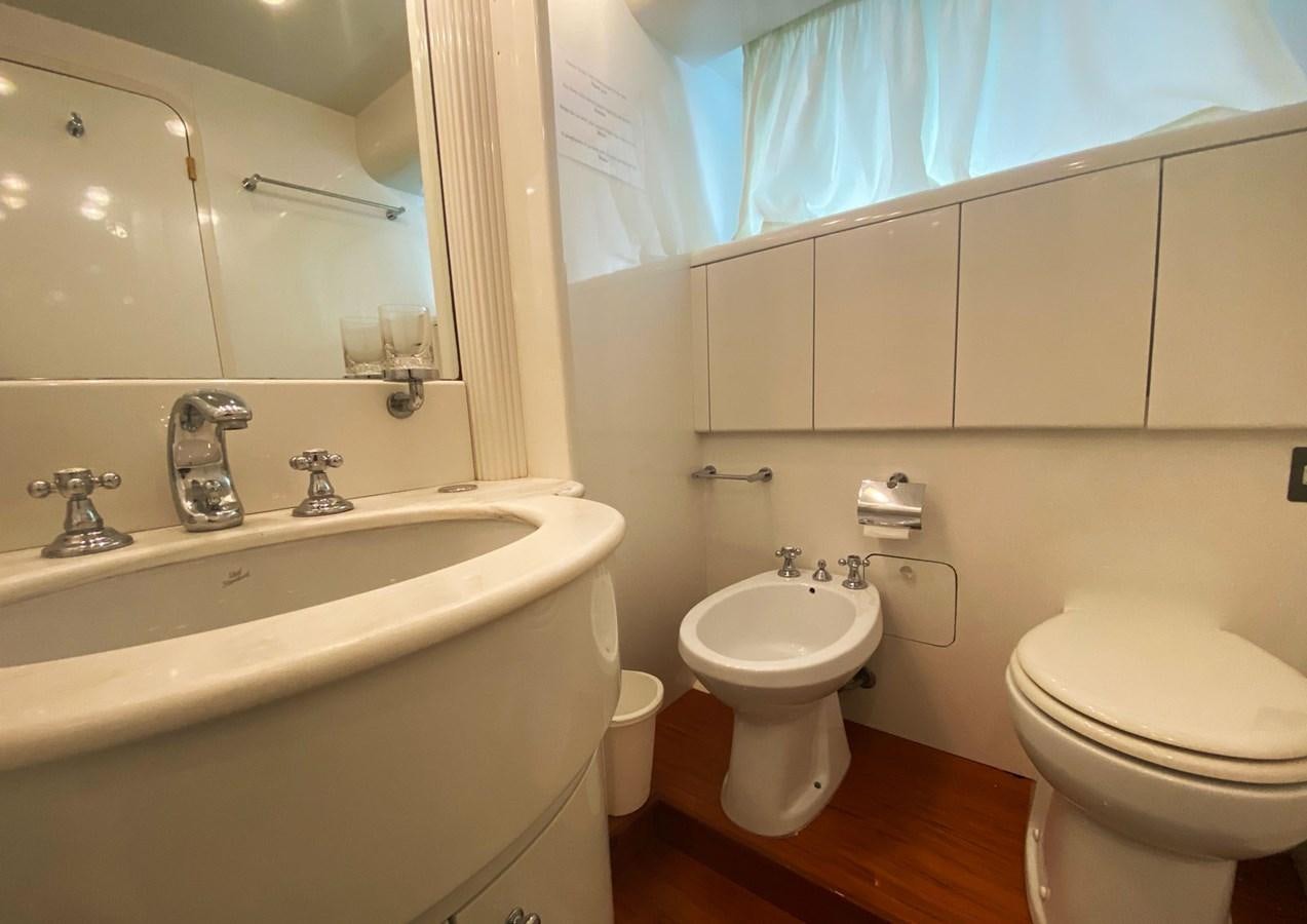a bathroom with a sink toilet and a bathtub aboard GRAN FINALE II Yacht for Sale