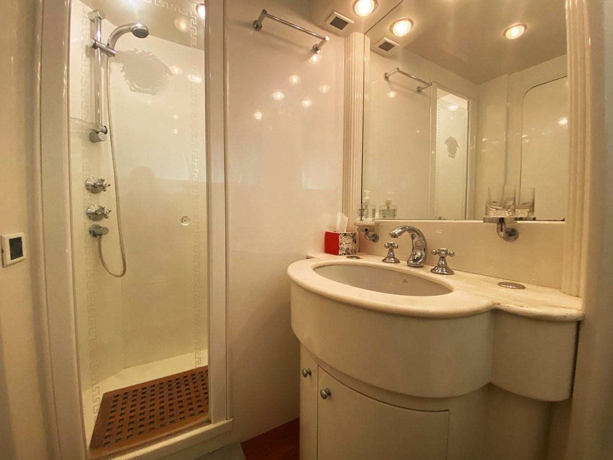 a bathroom with a shower and sink aboard GRAN FINALE II Yacht for Sale