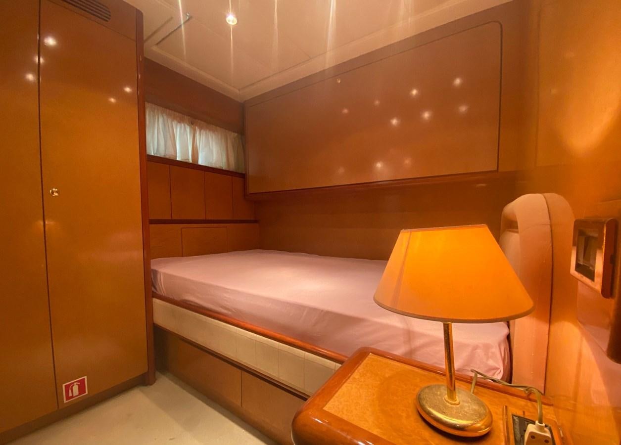 a hotel room with a bed and lamp aboard GRAN FINALE II Yacht for Sale