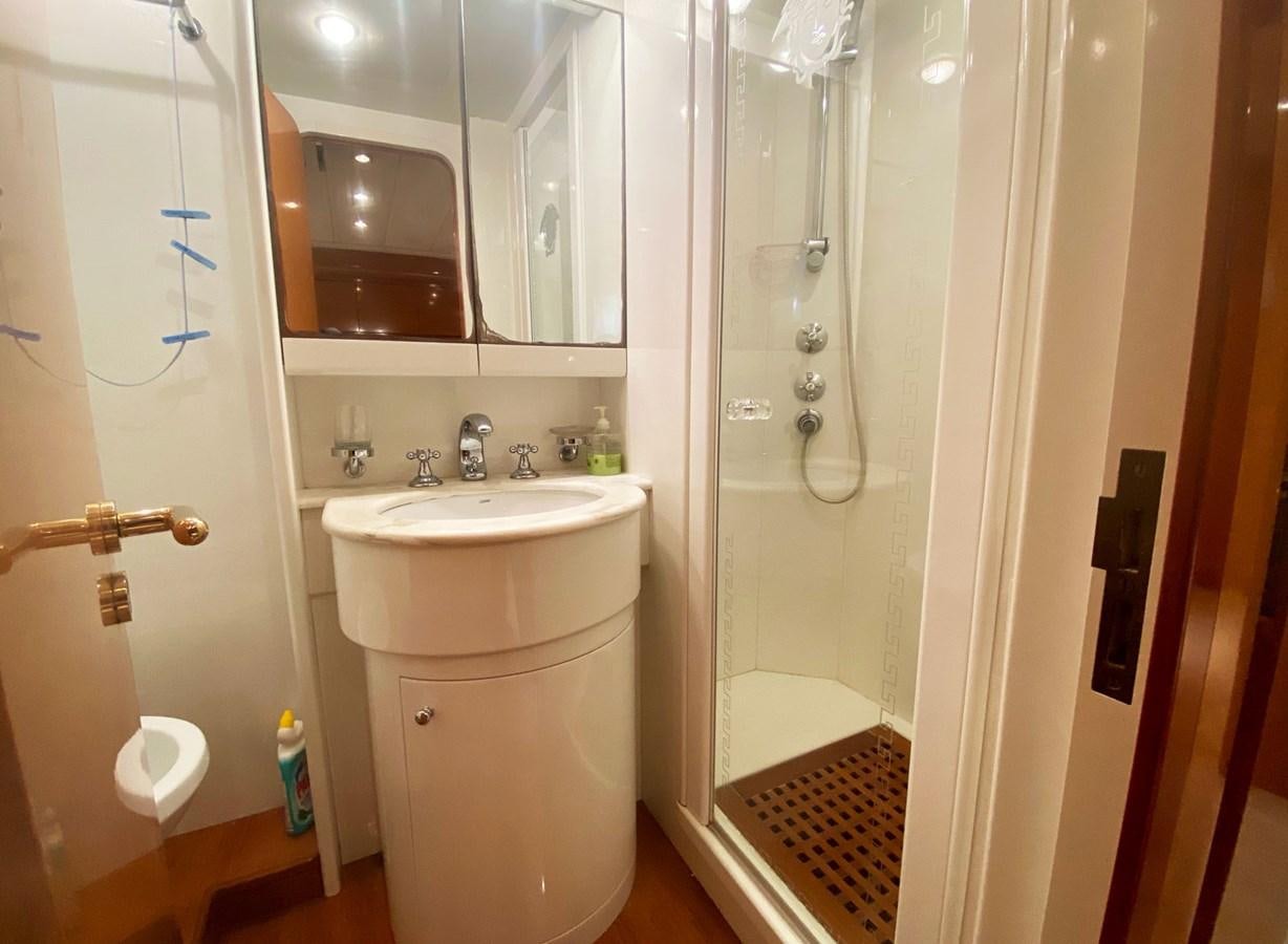 a bathroom with a glass shower aboard GRAN FINALE II Yacht for Sale