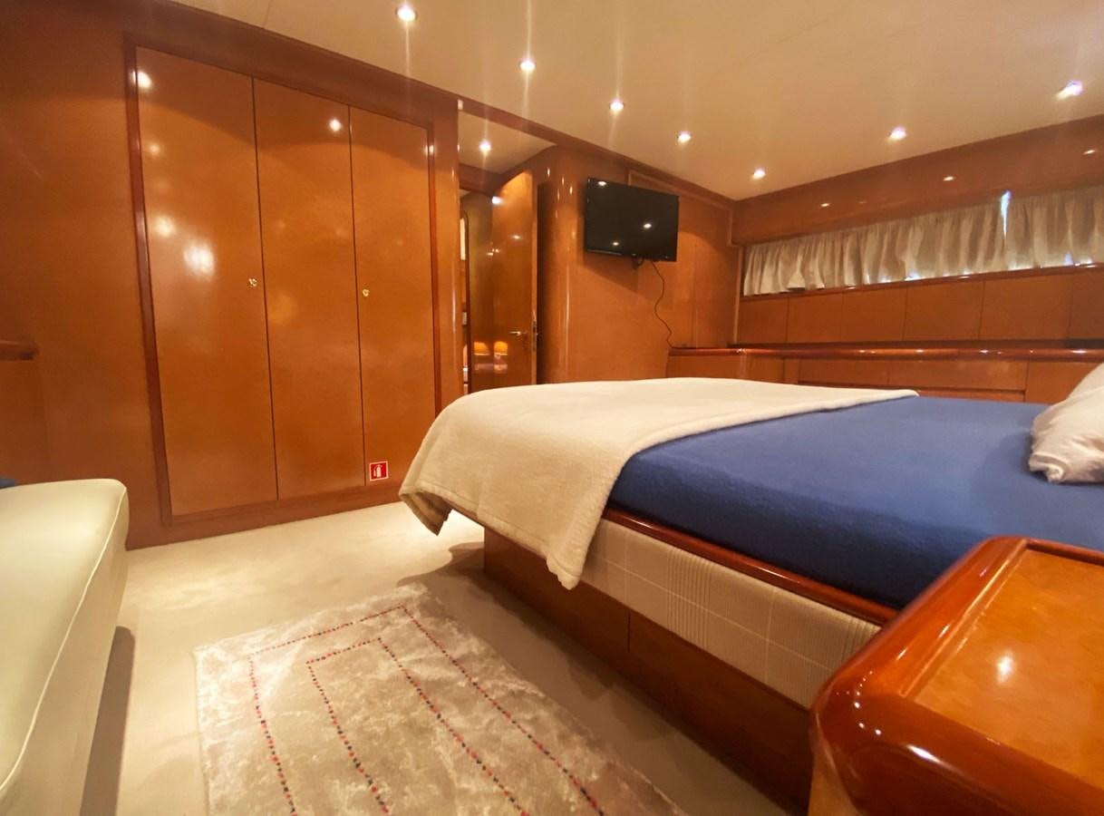 a room with a bed and a television aboard GRAN FINALE II Yacht for Sale