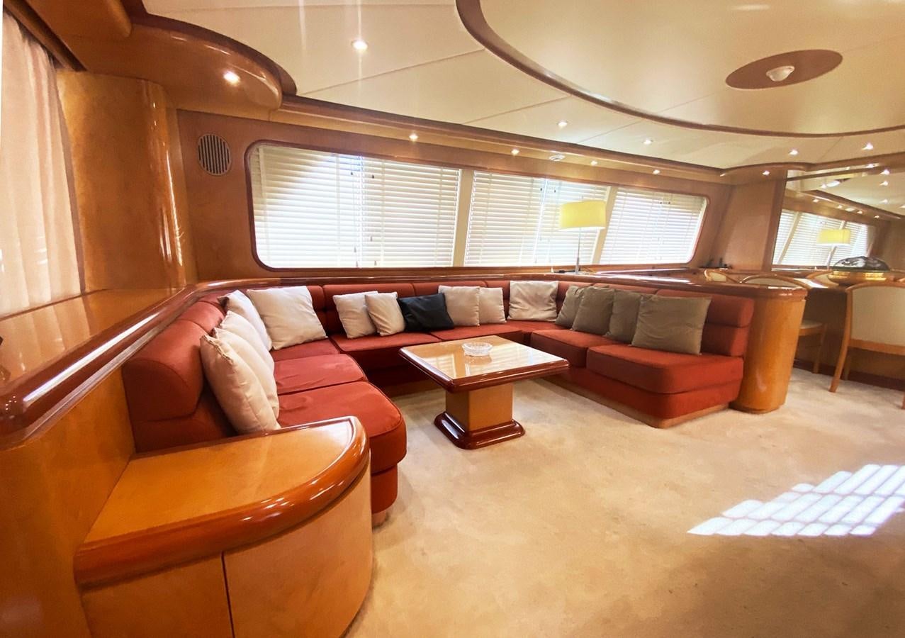 a living room with a couch and a coffee table aboard GRAN FINALE II Yacht for Sale