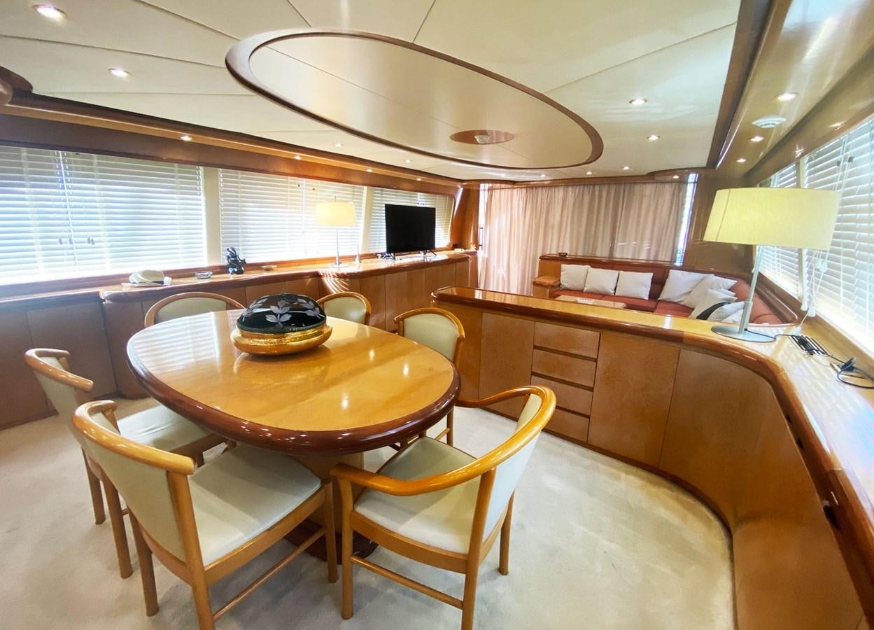 a room with a table and chairs aboard GRAN FINALE II Yacht for Sale