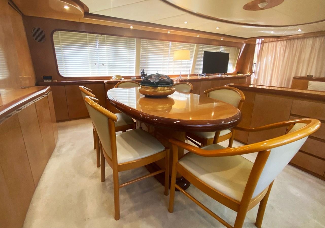 a dining table and chairs in a room aboard GRAN FINALE II Yacht for Sale