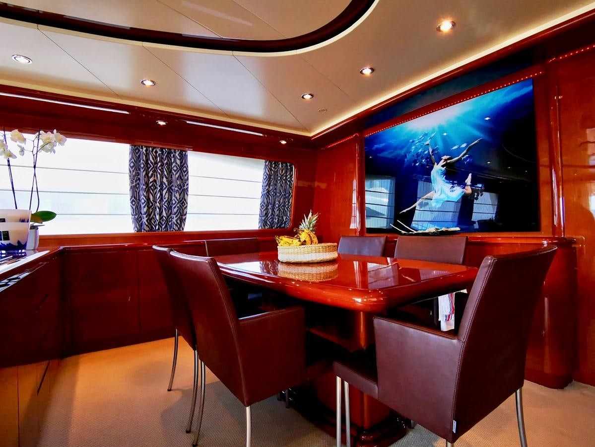 a room with red tables and chairs aboard V BOYS Yacht for Sale