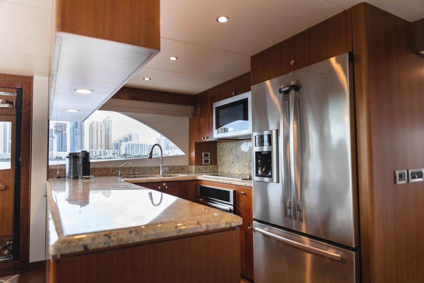 a kitchen with a stainless steel refrigerator aboard OCEAN ROSE Yacht for Sale