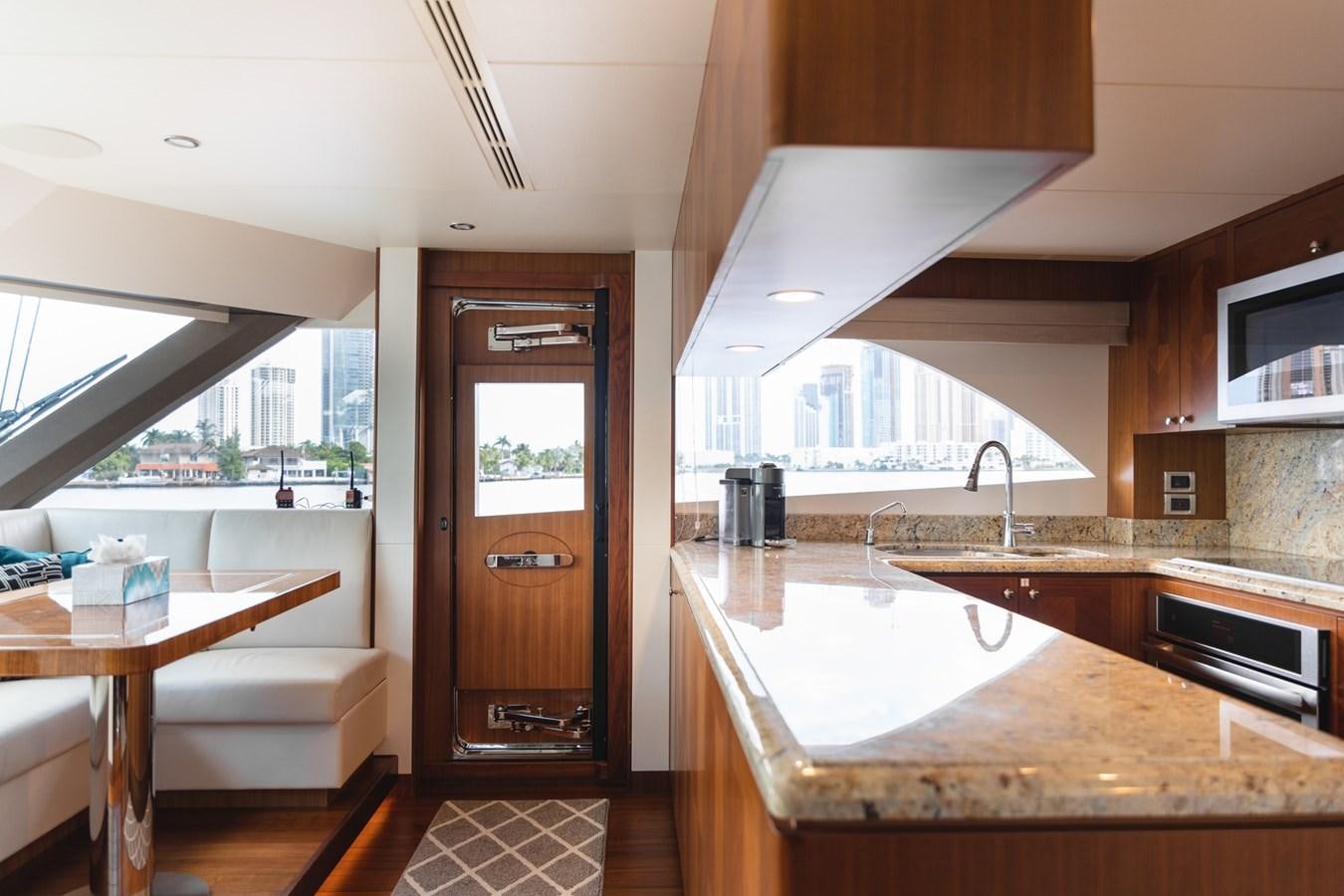 a kitchen with a large island aboard OCEAN ROSE Yacht for Sale