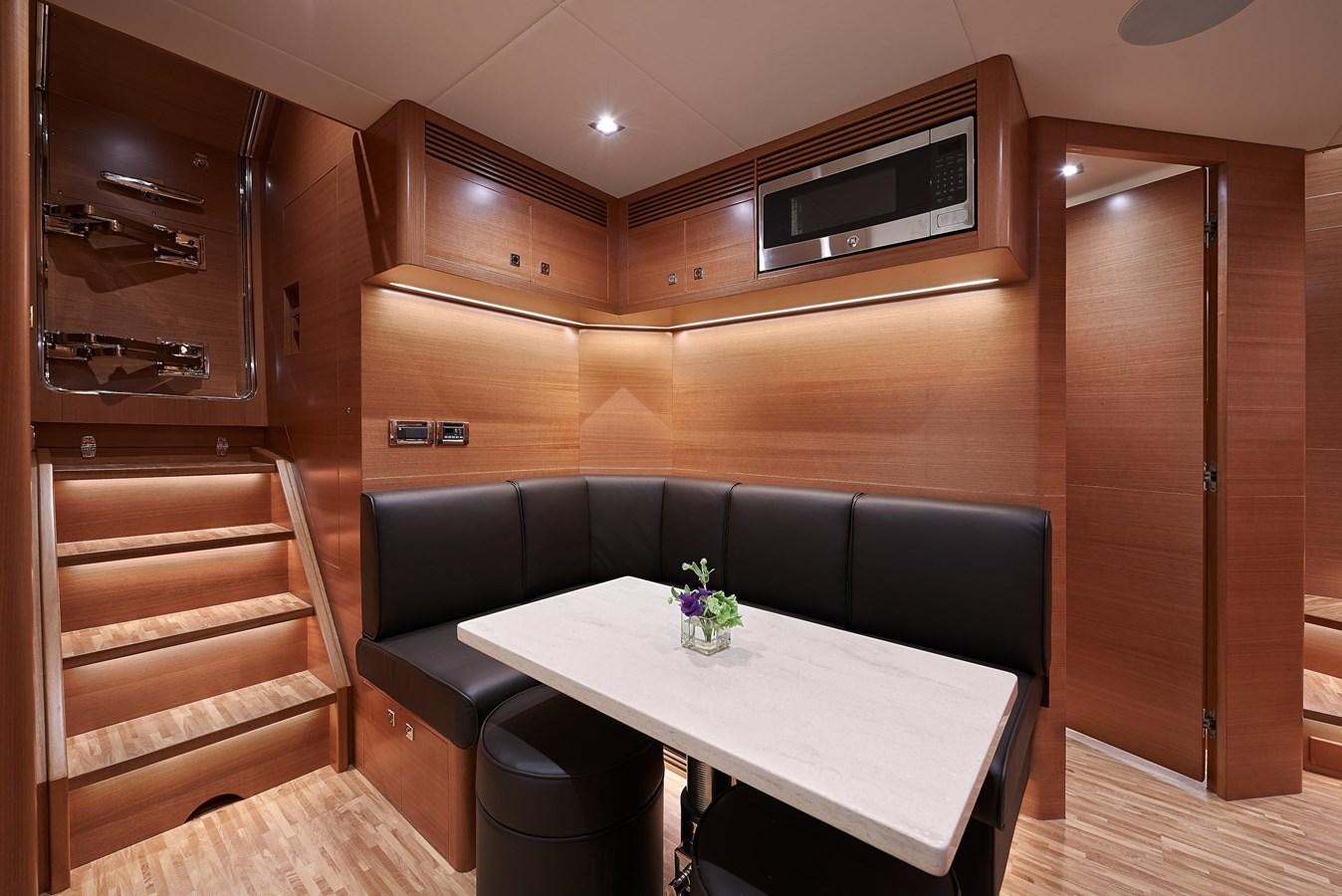 a room with a table and a couch aboard FD85 (NEW BOAT SPEC)  Yacht for Sale