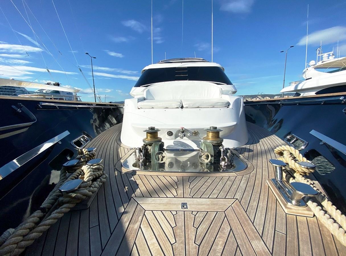 a white boat on a dock aboard PETARDO C Yacht for Sale