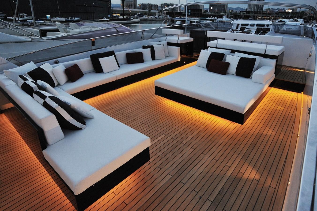 a room with a couch and a table with chairs aboard PETARDO C Yacht for Sale