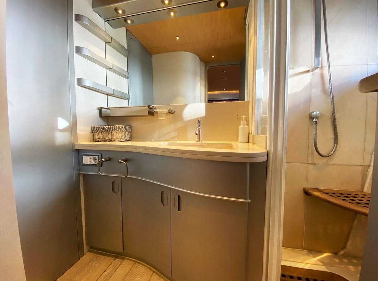 a bathroom with a sink and a mirror aboard PETARDO C Yacht for Sale