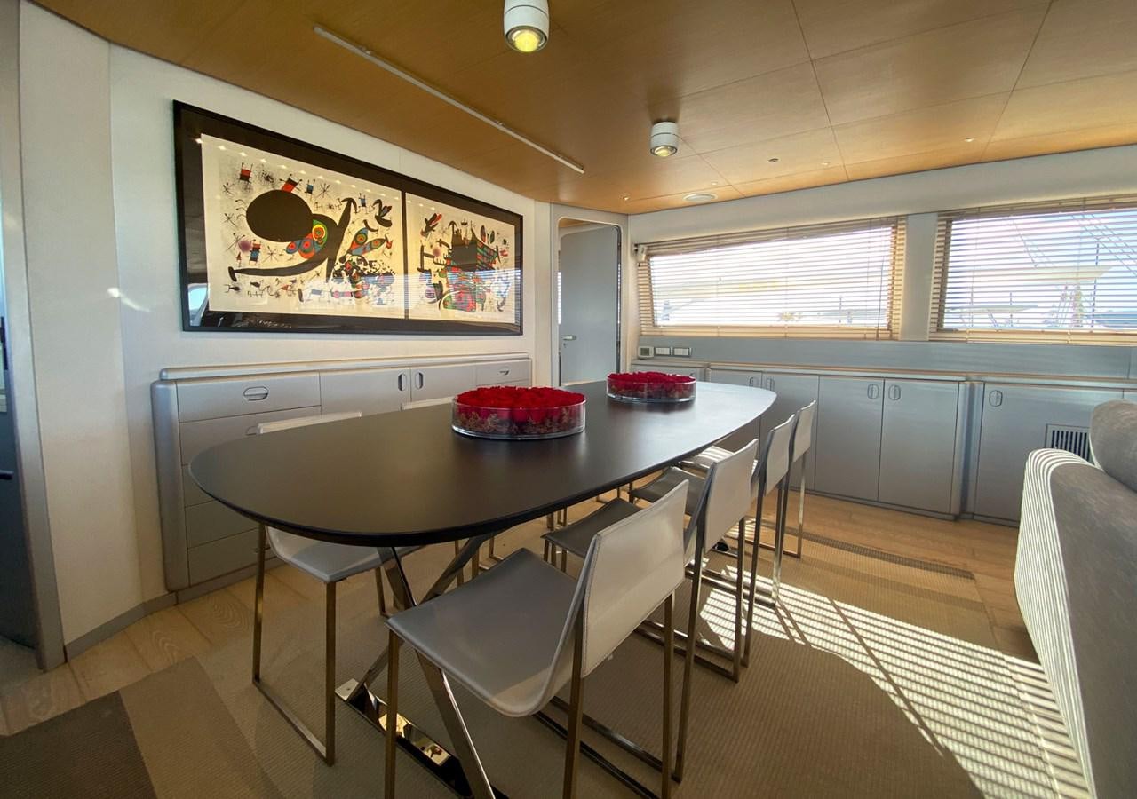 a kitchen with a table and chairs aboard PETARDO C Yacht for Sale