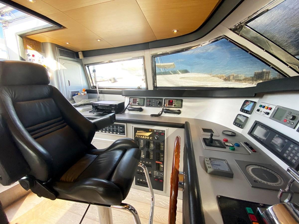 inside of a vehicle with a large screen and a seat with a seat and steering wheel aboard PETARDO C Yacht for Sale