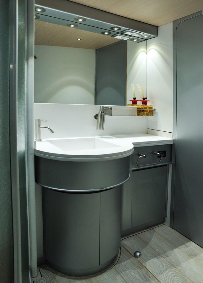 a bathroom with a sink and a mirror aboard PETARDO C Yacht for Sale