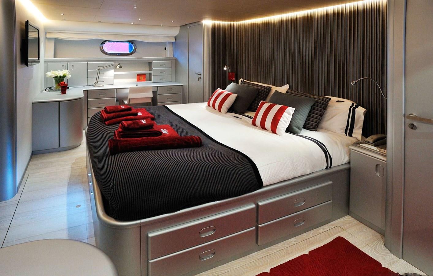 a bedroom with a bed and a desk aboard PETARDO C Yacht for Sale