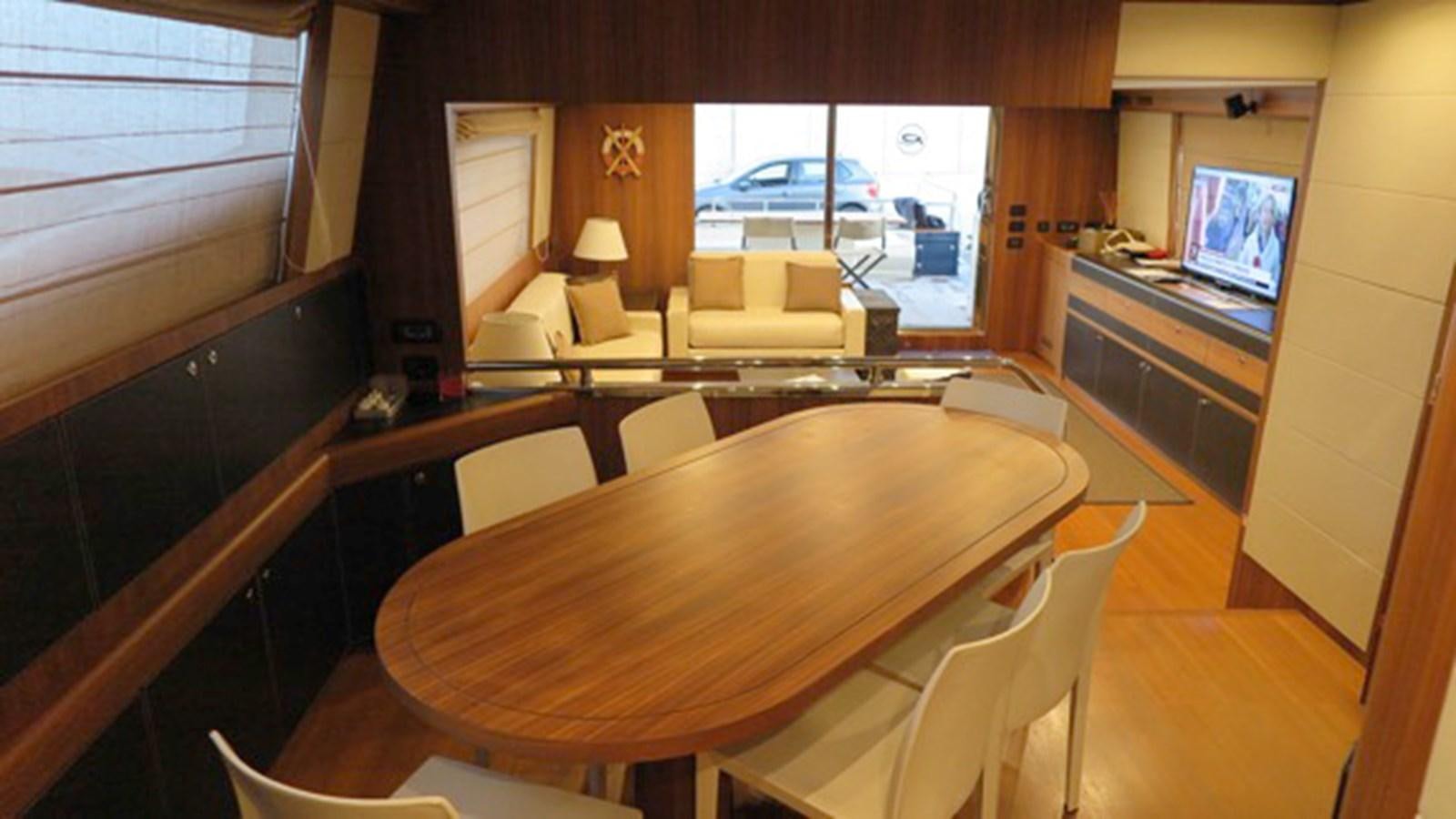 a room with a table and chairs aboard RIVA 85 OPERA Yacht for Sale