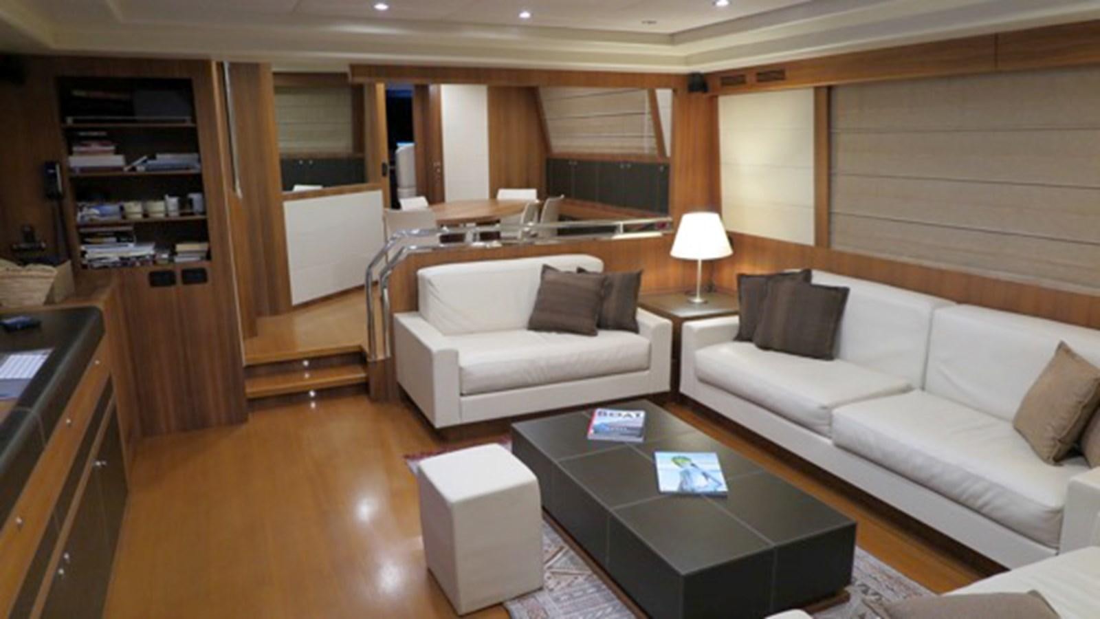 a living room with a couch and a coffee table aboard RIVA 85 OPERA Yacht for Sale