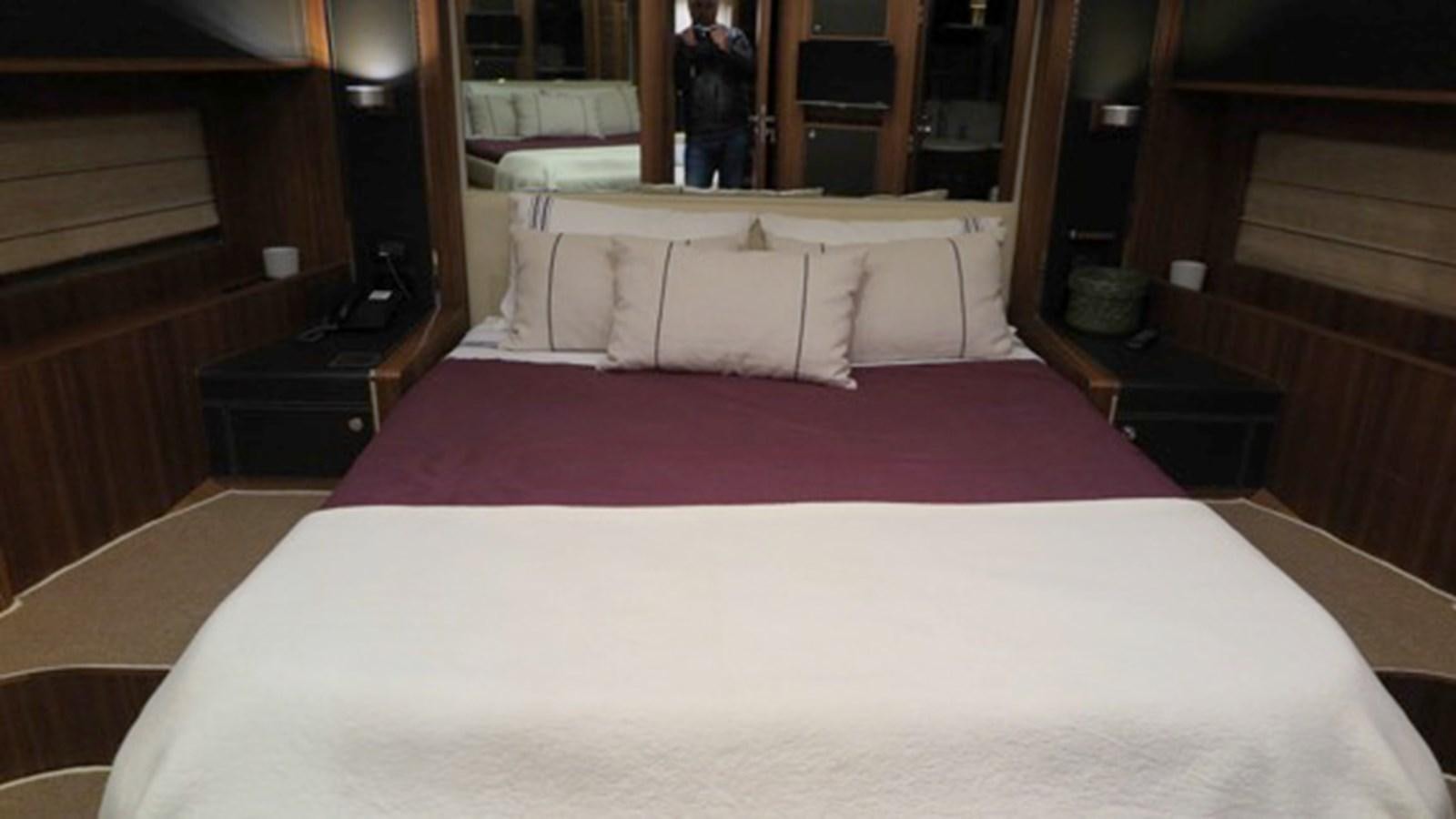 a bed with a red sheet aboard RIVA 85 OPERA Yacht for Sale