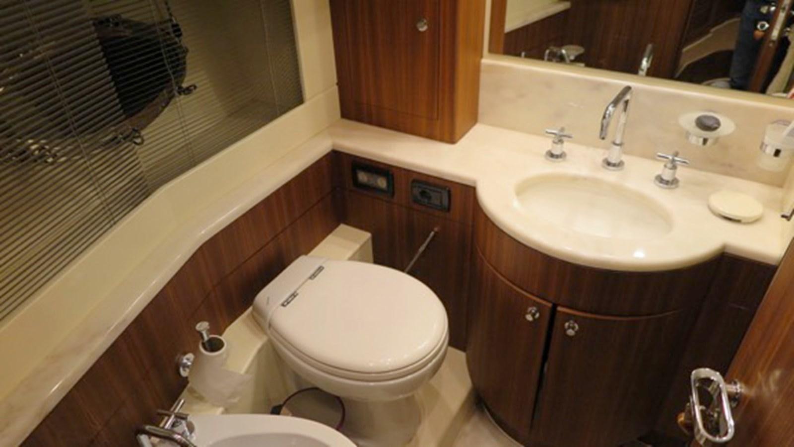 a bathroom with a toilet and sink aboard RIVA 85 OPERA Yacht for Sale