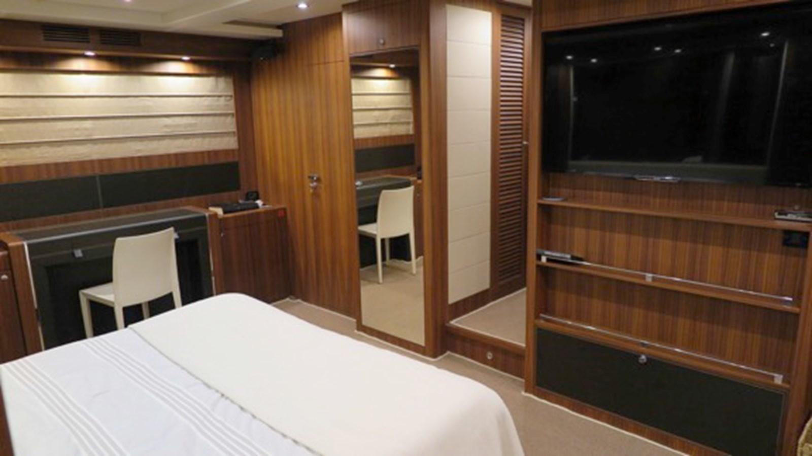 a room with a bed and a chair aboard RIVA 85 OPERA Yacht for Sale