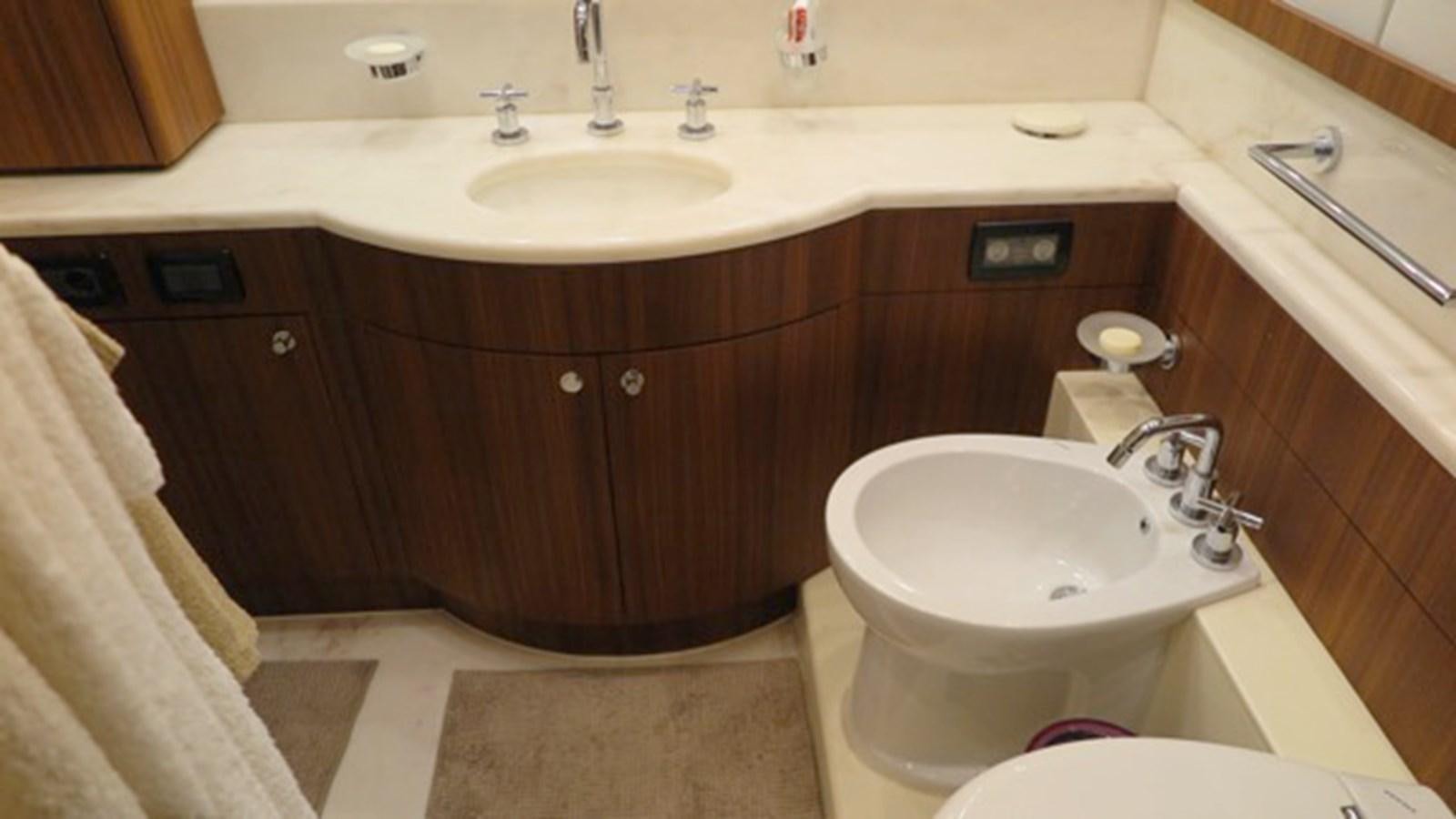 a bathroom with a sink and a toilet aboard RIVA 85 OPERA Yacht for Sale