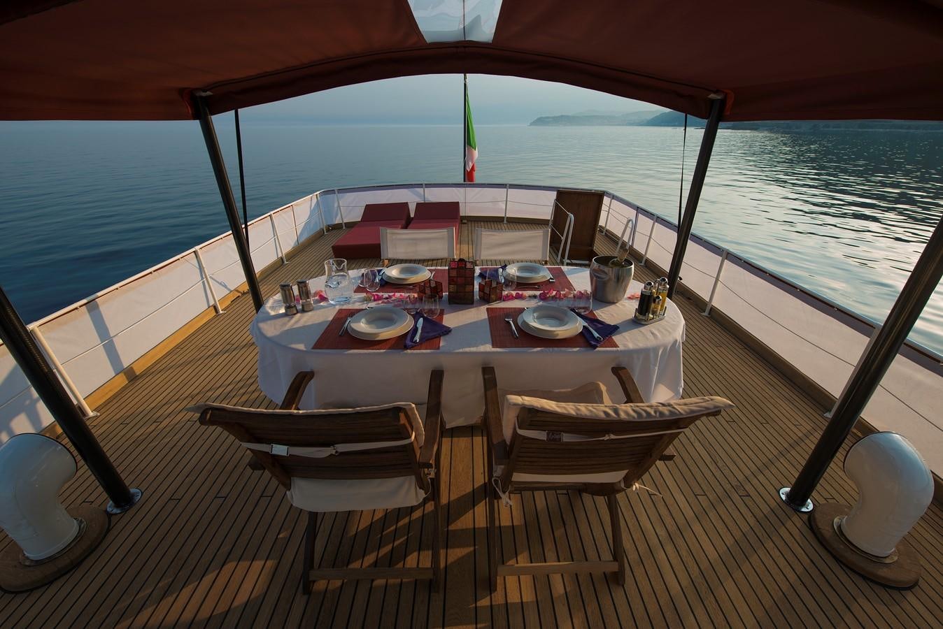 a dining table on a deck aboard EMERALD Yacht for Sale