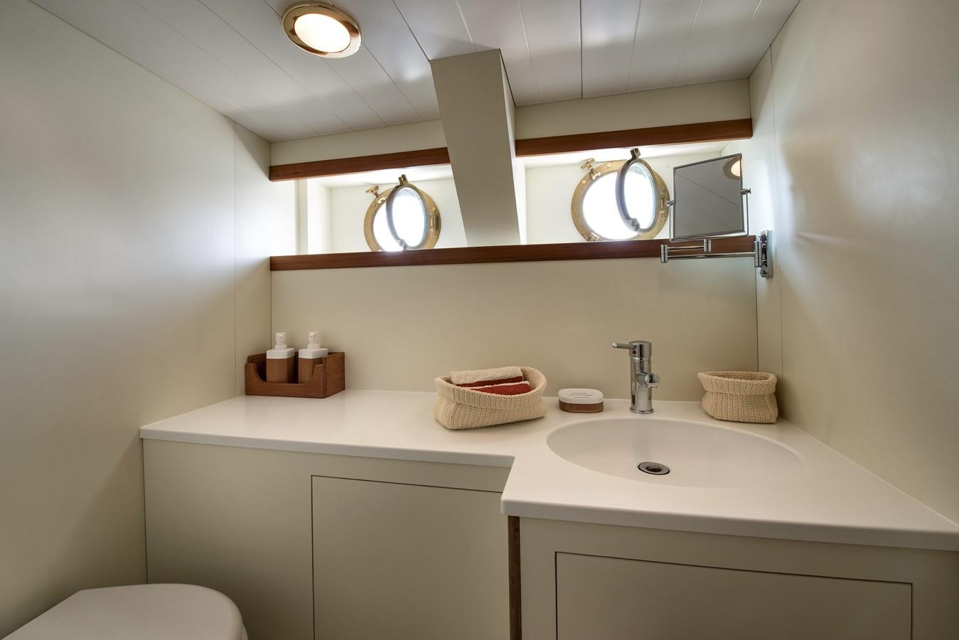 a bathroom with a sink and a mirror aboard EMERALD Yacht for Sale