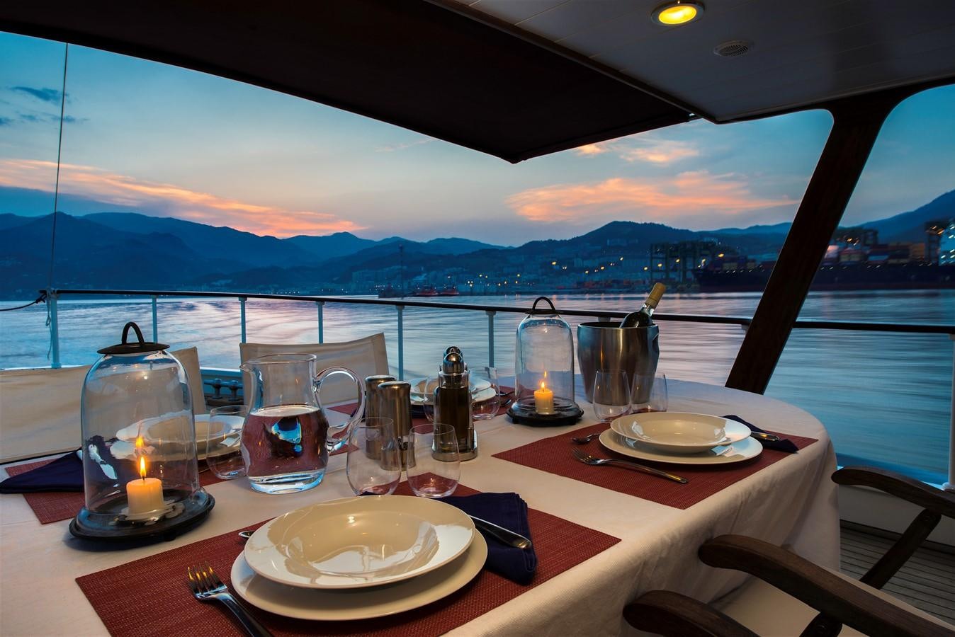 a table with plates and glasses on it aboard EMERALD Yacht for Sale