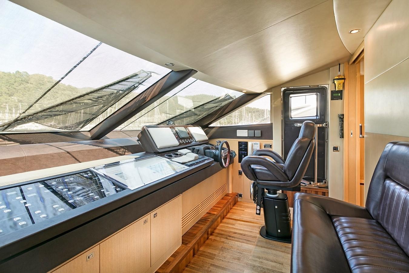 inside of a vehicle with a large screen and a laptop on the dashboard aboard DREAM ON Yacht for Sale