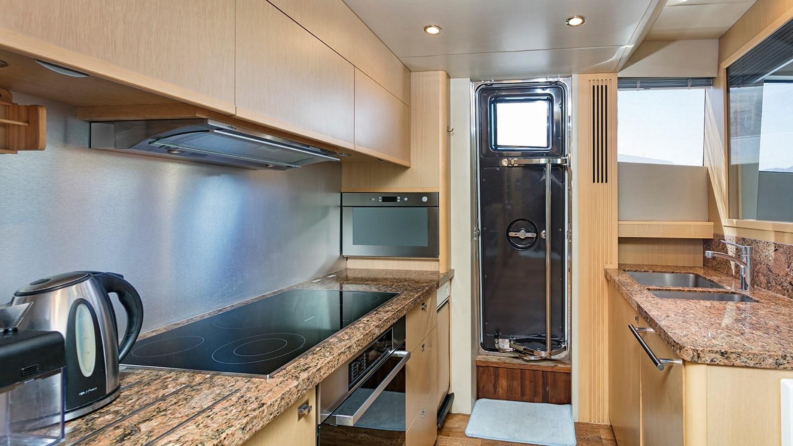 a kitchen with a sink and a refrigerator aboard DREAM ON Yacht for Sale