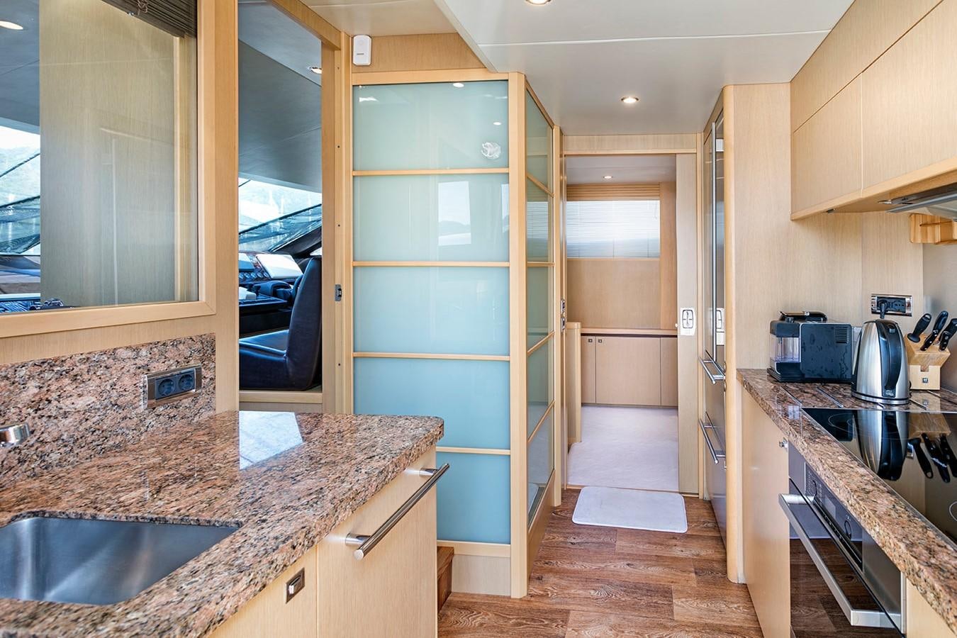 a kitchen with a glass door aboard DREAM ON Yacht for Sale