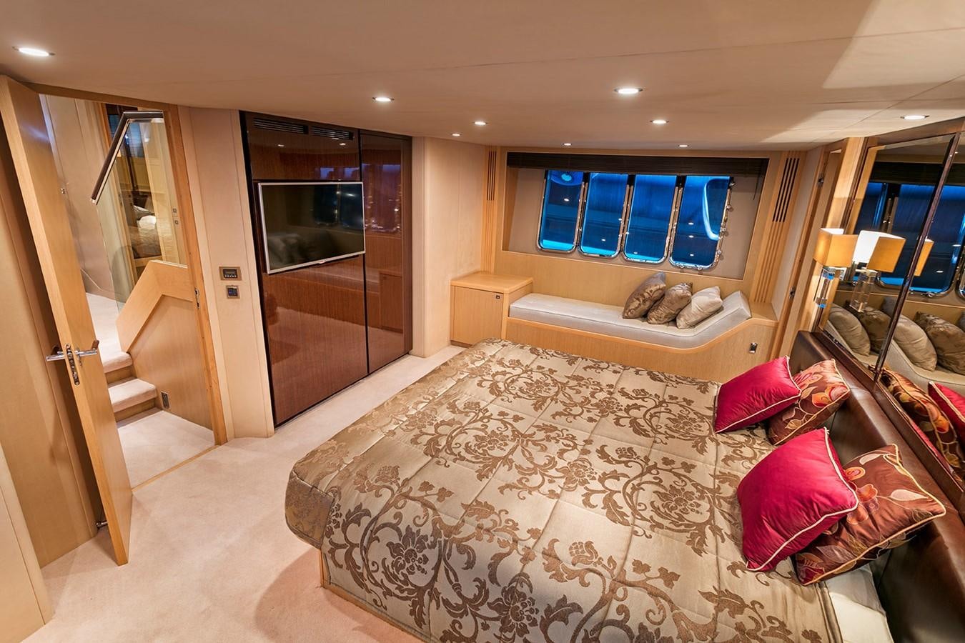 a bedroom with a bed and a mirror aboard DREAM ON Yacht for Sale