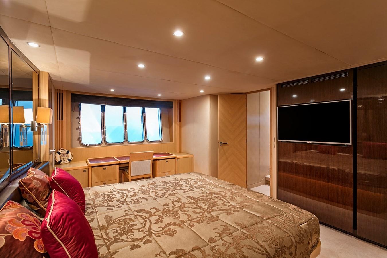 a bedroom with a bed and a desk aboard DREAM ON Yacht for Sale