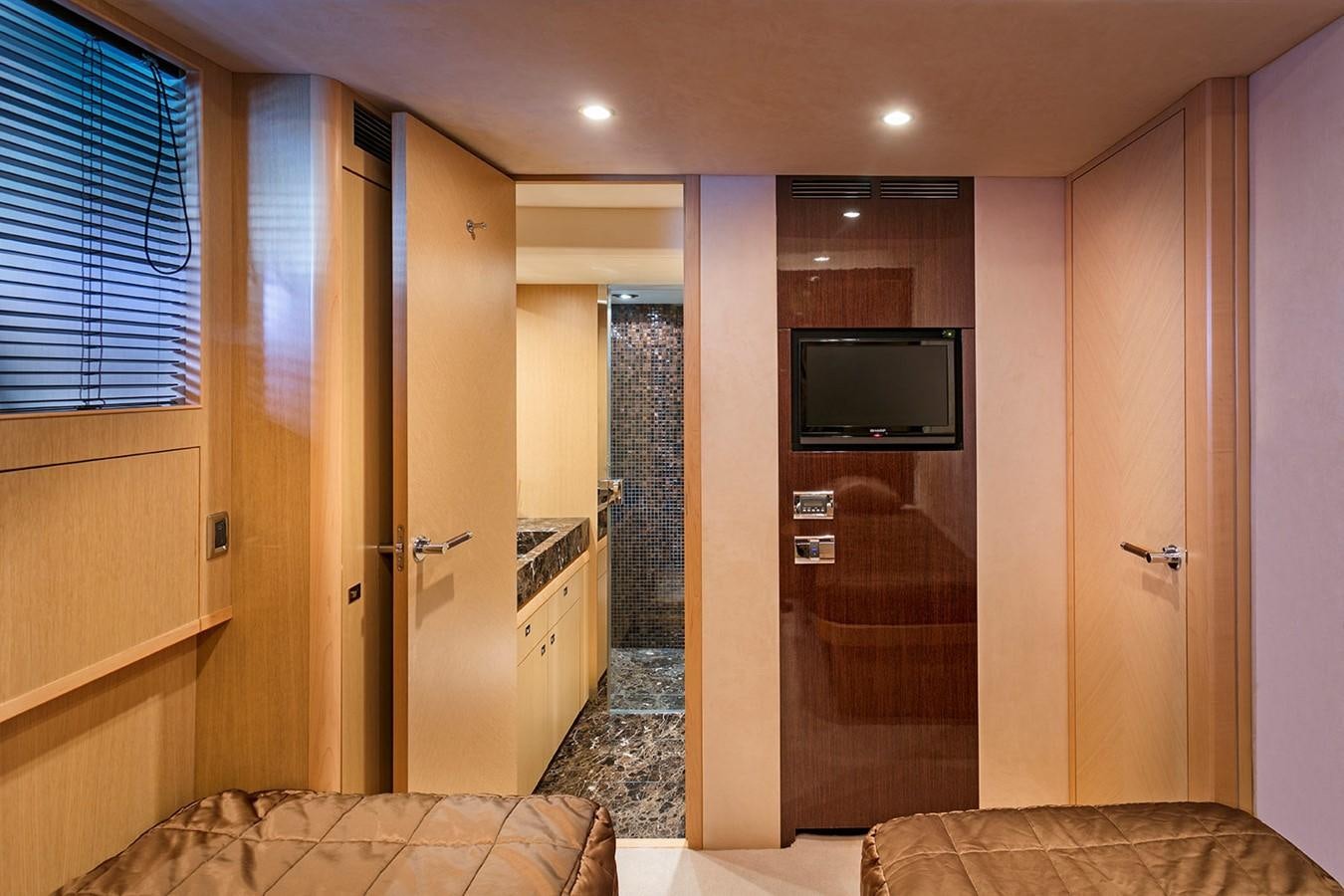 a bedroom with a bed and tv aboard DREAM ON Yacht for Sale