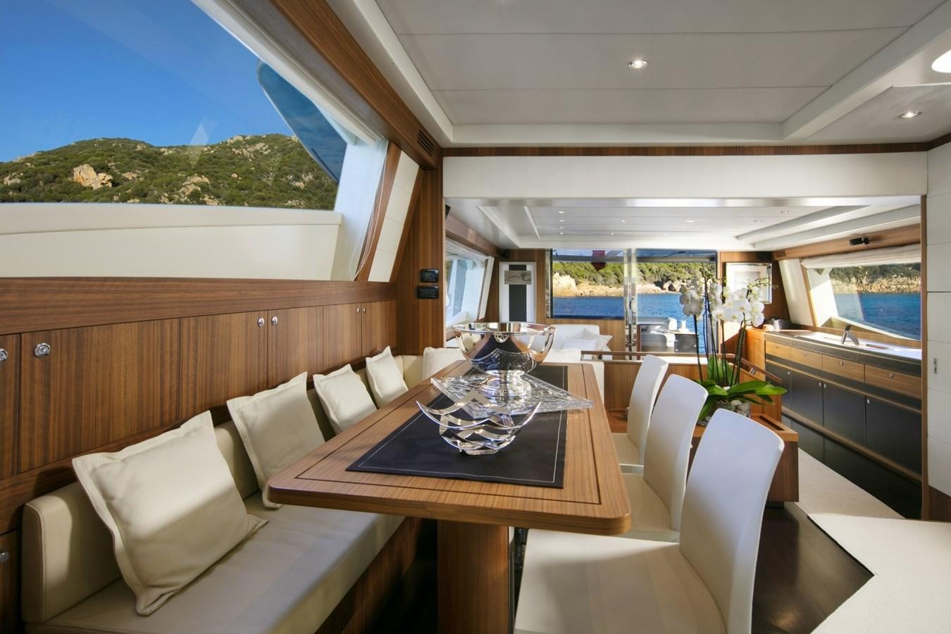 a room with a table chairs and a couch aboard BLACK PEARL AJACCIO Yacht for Sale