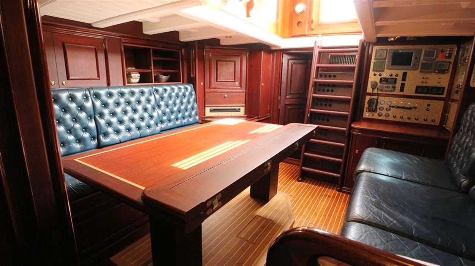 a room with a couch and a table aboard SKY Yacht for Sale