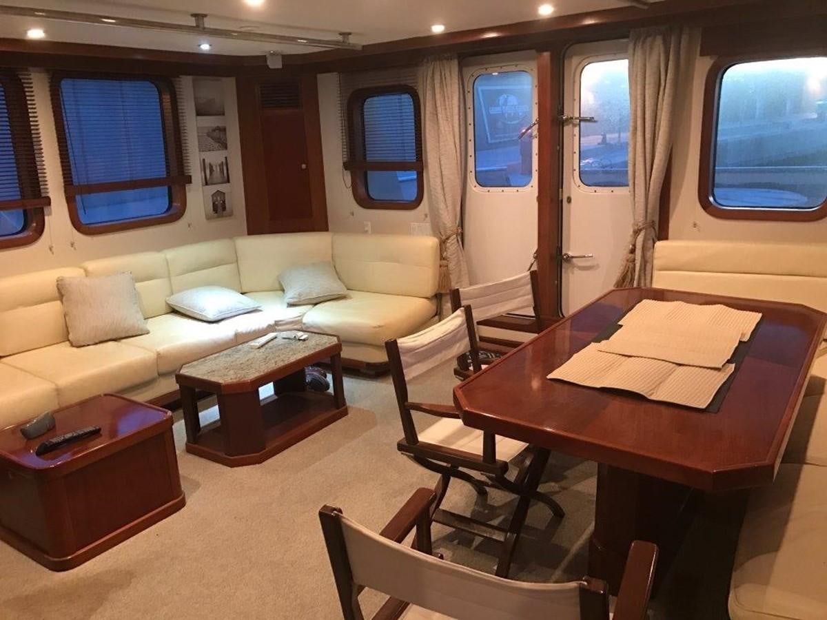 a living room with a couch and a table aboard BELEZA Yacht for Sale