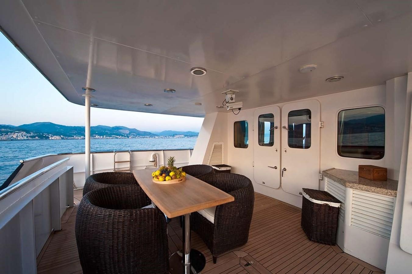 a table and chairs on a boat aboard BELEZA Yacht for Sale