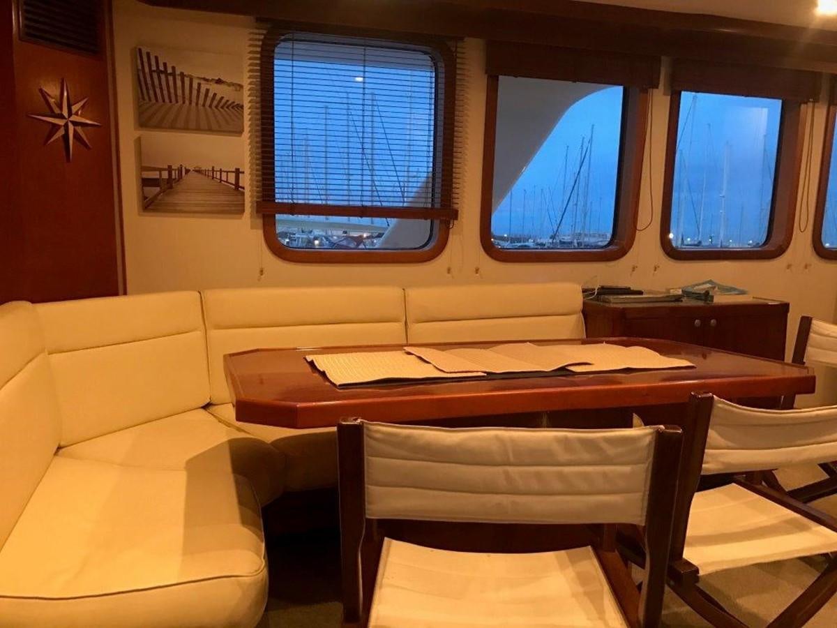 a room with a table and chairs aboard BELEZA Yacht for Sale