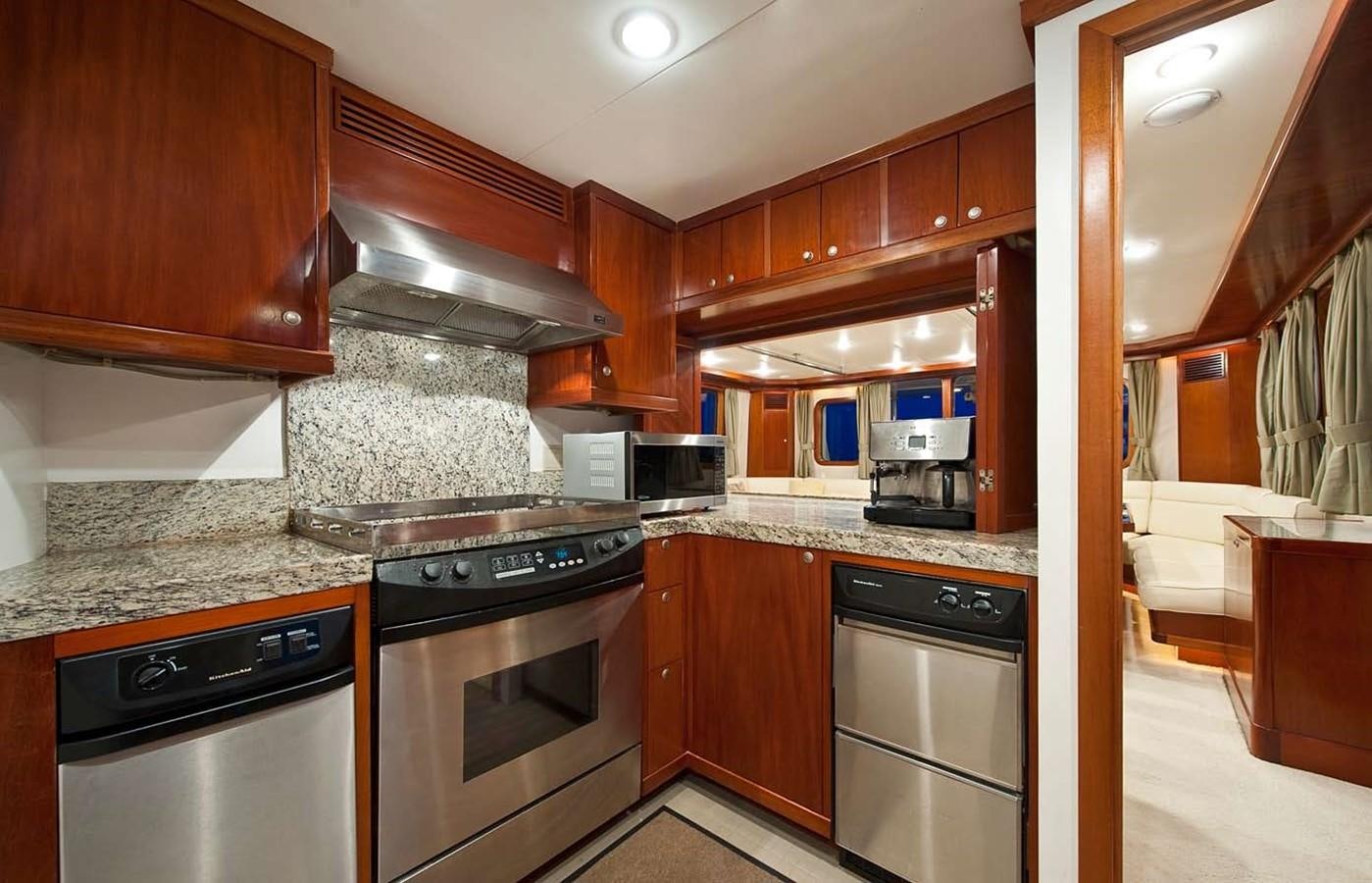 a kitchen with wooden cabinets aboard BELEZA Yacht for Sale