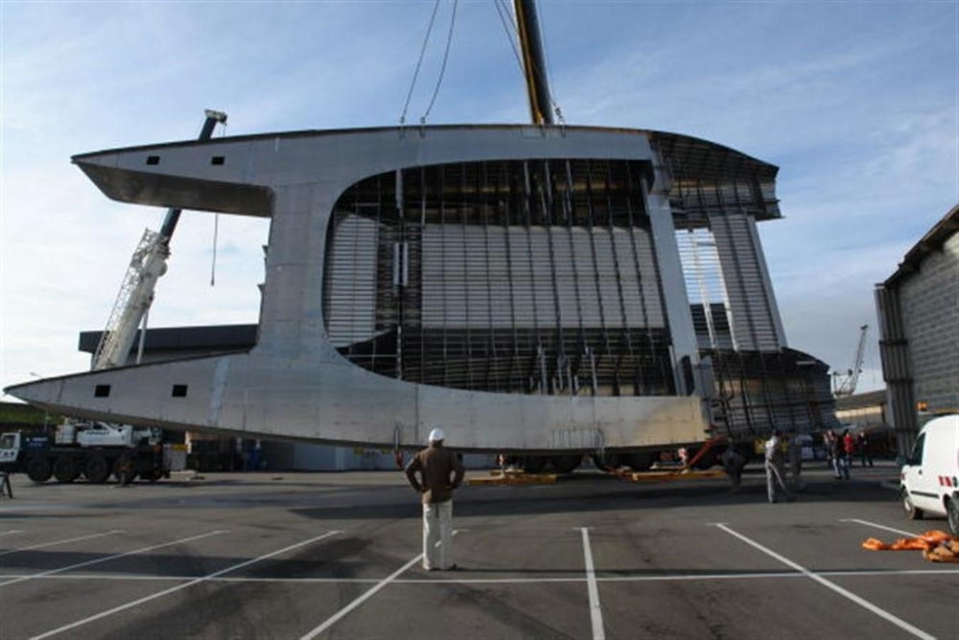 a person standing in front of a large building aboard 85' 2008 YAPLUKA 85 DOUBLE DECK Yacht for Sale