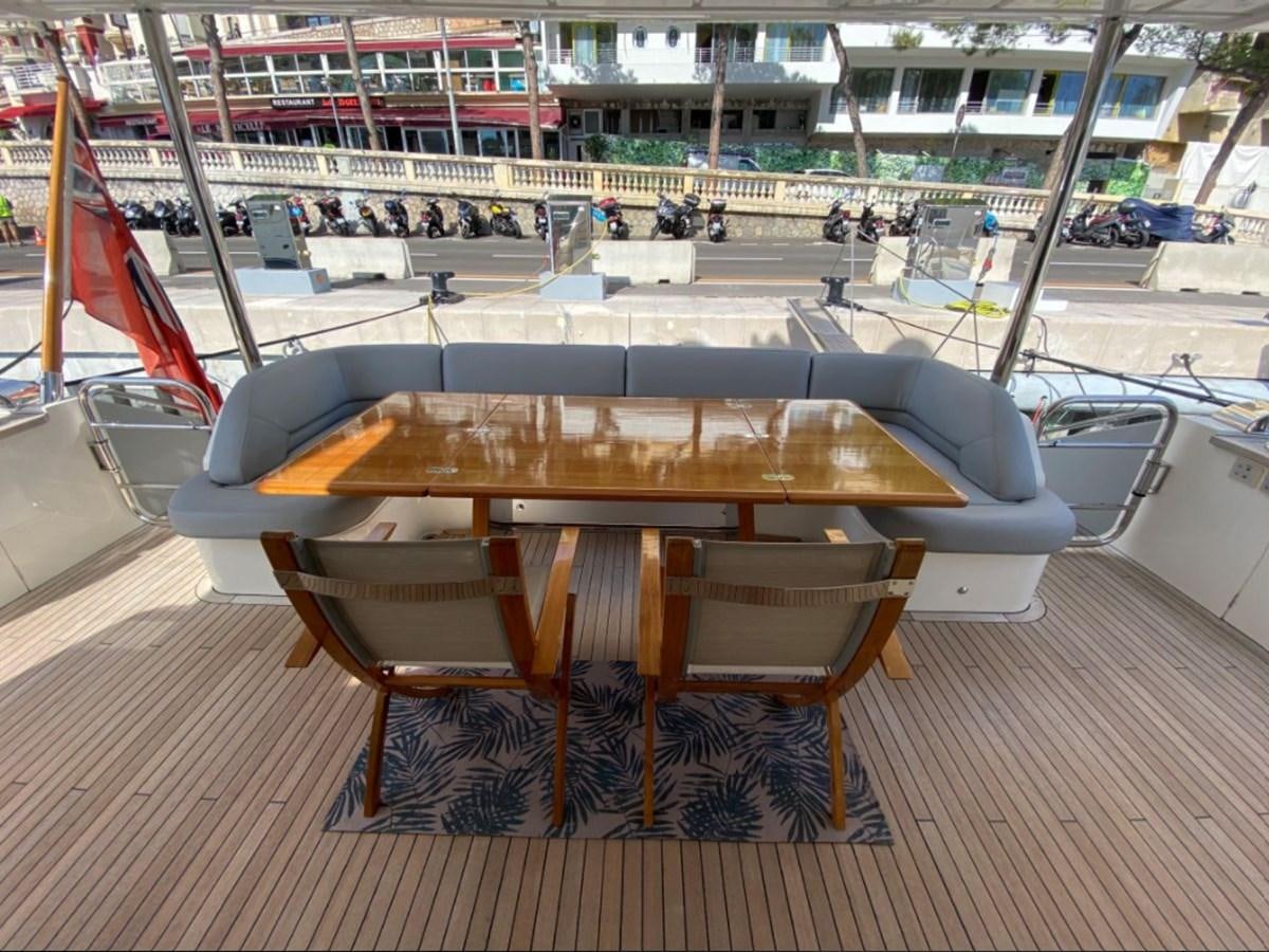 a table with a flag on it aboard MOONDANCER Yacht for Sale