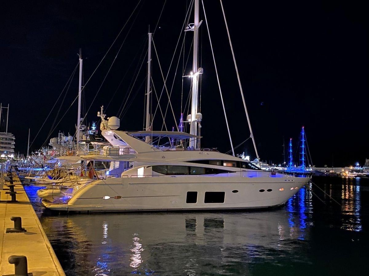 a boat docked at night aboard MOONDANCER Yacht for Sale